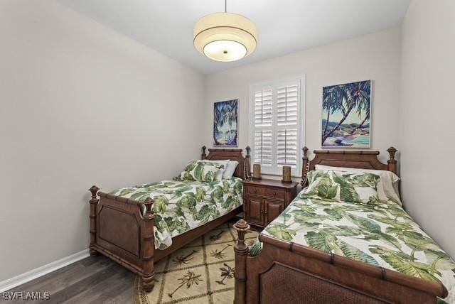 bedroom with dark wood-type flooring