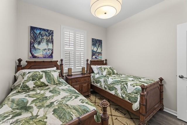 bedroom with dark hardwood / wood-style floors