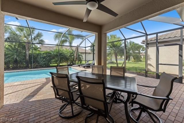 exterior space featuring ceiling fan and glass enclosure