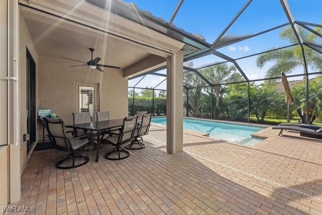 view of swimming pool with a lanai, a patio area, and ceiling fan