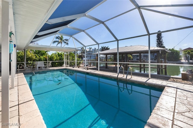 outdoor pool with glass enclosure and a patio