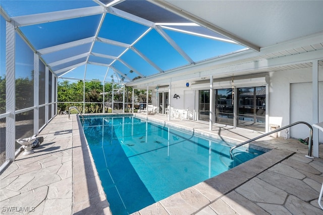 pool with glass enclosure and a patio