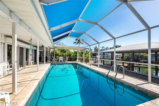 pool with glass enclosure and a patio