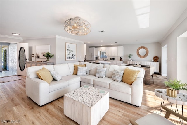 living room featuring light wood-type flooring, visible vents, recessed lighting, an inviting chandelier, and crown molding