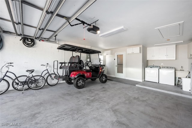 garage featuring a garage door opener and washing machine and clothes dryer