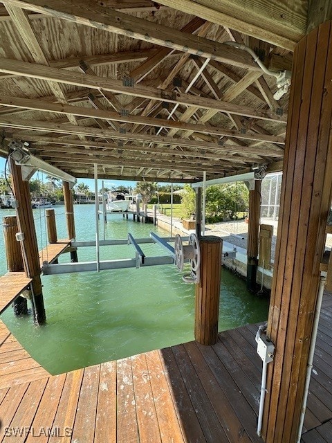 dock area with a water view and boat lift