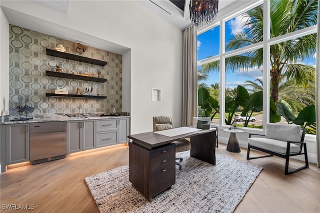 office featuring bar area and light hardwood / wood-style flooring