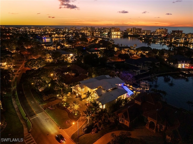 aerial view at dusk with a water view