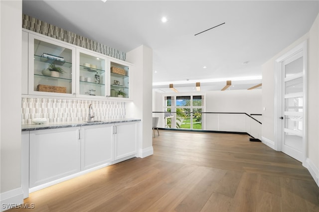 corridor featuring light hardwood / wood-style floors and sink