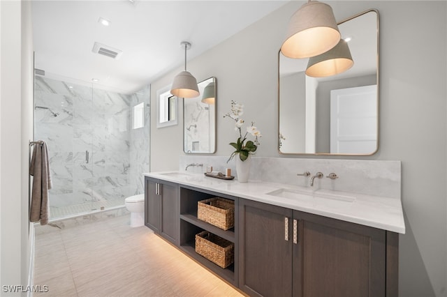 bathroom featuring vanity, backsplash, a shower with door, and toilet