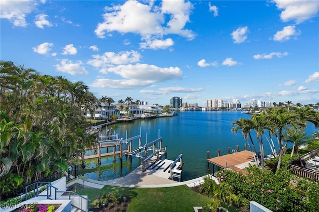 dock area with a lawn and a water view