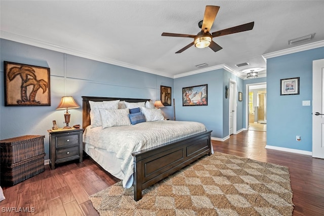 bedroom with hardwood / wood-style floors, ornamental molding, and ceiling fan