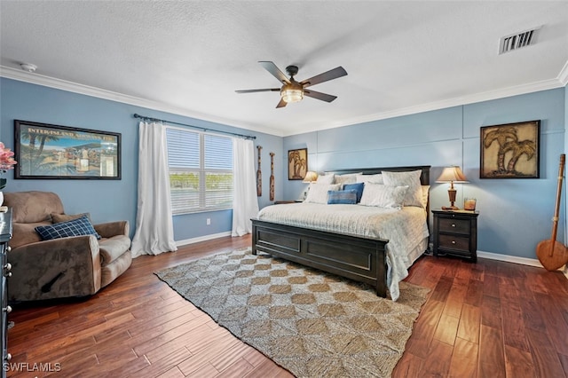 bedroom with dark hardwood / wood-style flooring, ornamental molding, and a textured ceiling