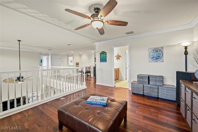 living room featuring dark wood-type flooring, ceiling fan, and crown molding