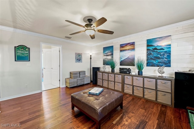 living room with crown molding, dark wood-type flooring, and ceiling fan