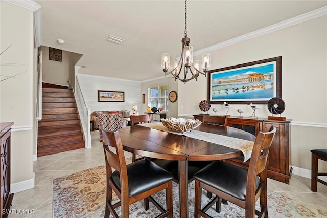 tiled dining space featuring ornamental molding and an inviting chandelier