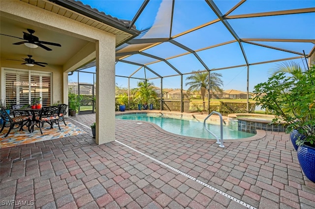 view of pool with a lanai, a patio, ceiling fan, and an in ground hot tub