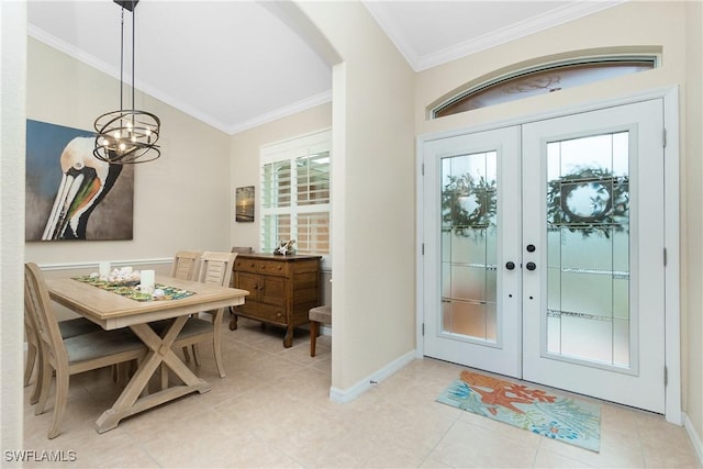 tiled entryway featuring vaulted ceiling, ornamental molding, french doors, and a healthy amount of sunlight