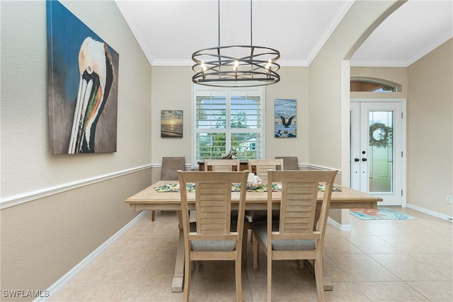 tiled dining space featuring crown molding, plenty of natural light, and a chandelier