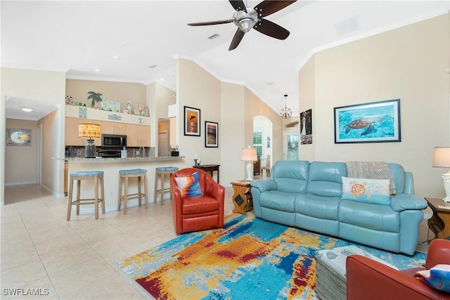 tiled living room featuring ornamental molding, ceiling fan, and high vaulted ceiling