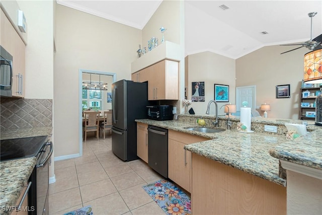 kitchen featuring sink, light stone counters, light tile patterned floors, appliances with stainless steel finishes, and ceiling fan