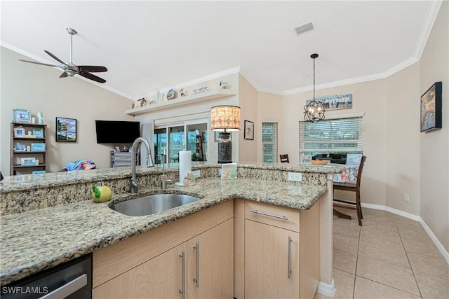 kitchen with dishwasher, light stone countertops, sink, and light brown cabinets