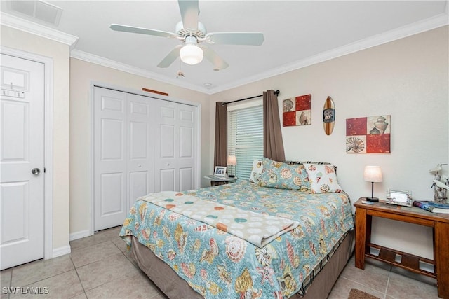 tiled bedroom with ceiling fan, ornamental molding, and a closet