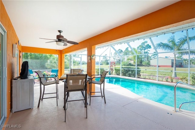 view of pool featuring ceiling fan, a lanai, and a patio area