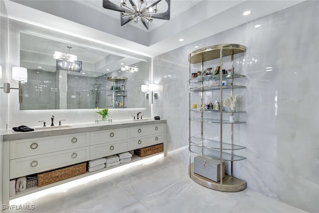 bathroom featuring walk in shower, vanity, a chandelier, and tile walls