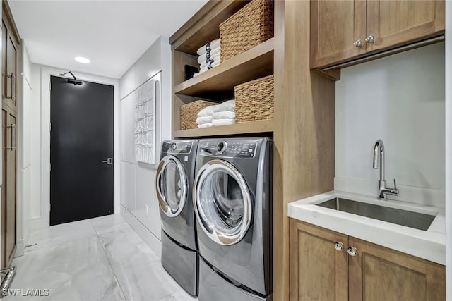 laundry room with cabinets, sink, and washer and dryer