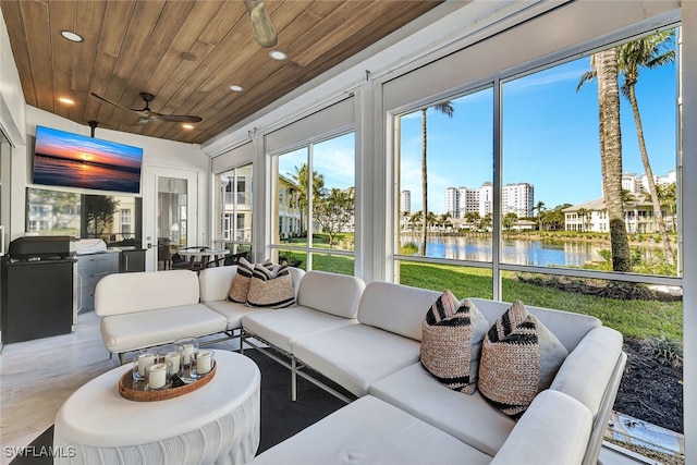 sunroom with a water view, ceiling fan, and wood ceiling