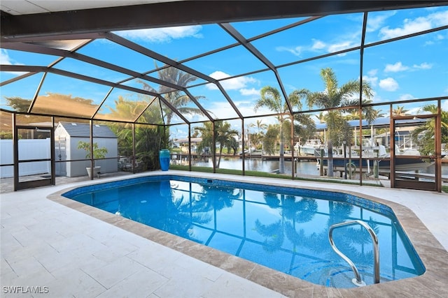 view of swimming pool featuring a water view, a lanai, and a patio area