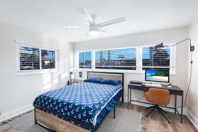 bedroom with ceiling fan and wood-type flooring