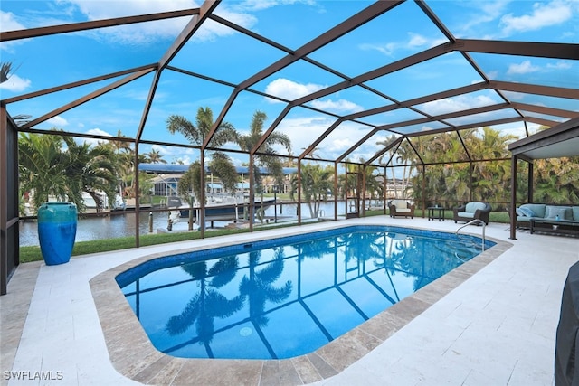 view of pool featuring a water view, glass enclosure, and a patio