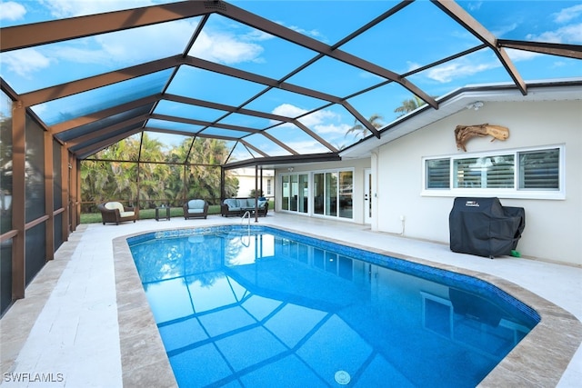 view of pool featuring a patio, area for grilling, and glass enclosure