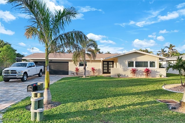 single story home featuring a front yard and a garage