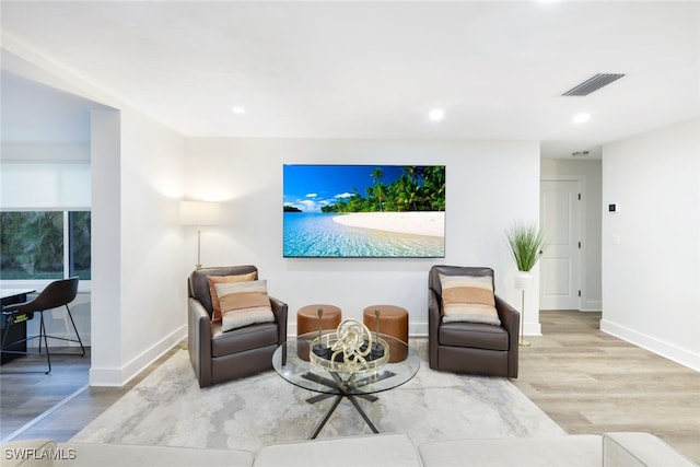 living area with light hardwood / wood-style flooring