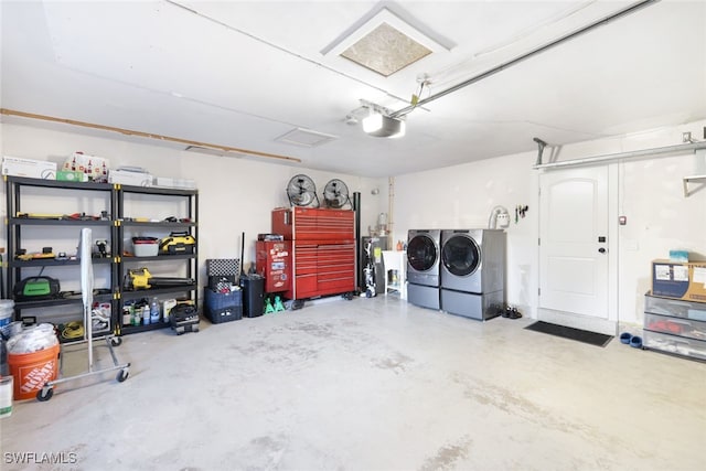 garage with washer and clothes dryer and a garage door opener