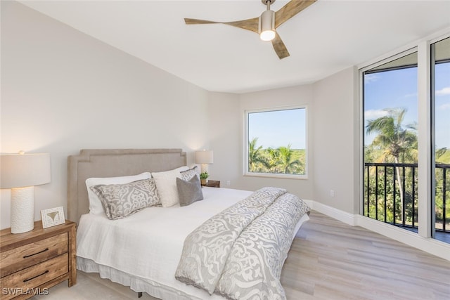 bedroom featuring ceiling fan, access to exterior, and light hardwood / wood-style flooring