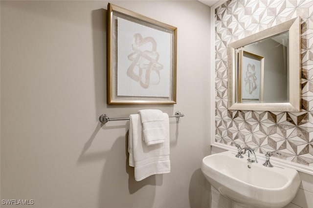 bathroom featuring tasteful backsplash and sink