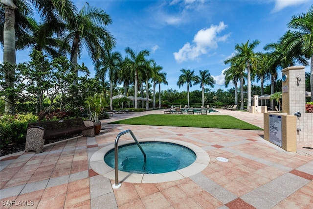 view of swimming pool with a hot tub and a patio