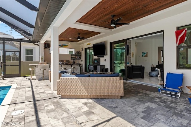 view of patio featuring ceiling fan, a lanai, and area for grilling