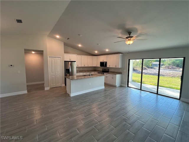 kitchen with visible vents, open floor plan, an island with sink, stainless steel appliances, and white cabinetry