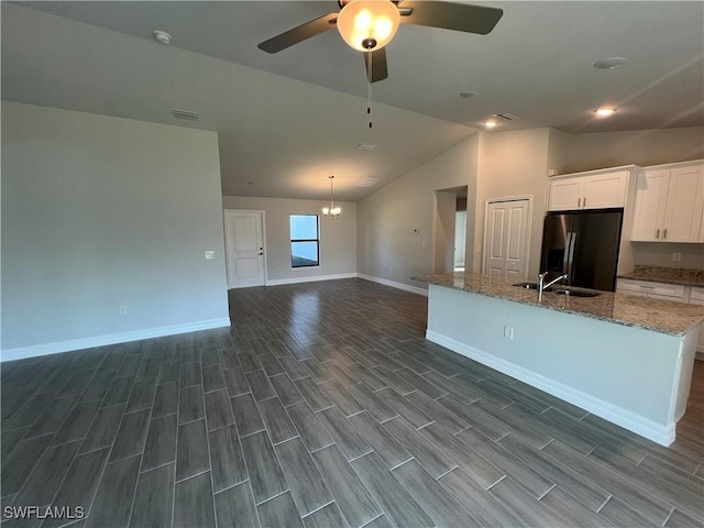 kitchen featuring wood finish floors, white cabinets, refrigerator with ice dispenser, and a sink