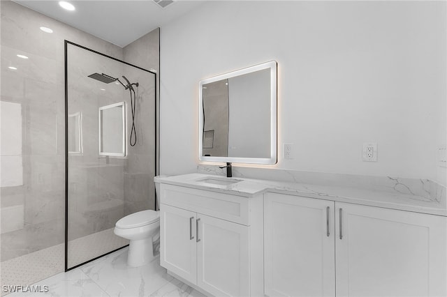 bathroom featuring vanity, toilet, and tiled shower