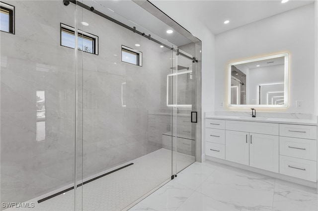 bathroom with vanity and a shower with door