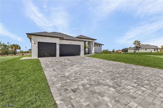 view of front of property with a garage and a front yard