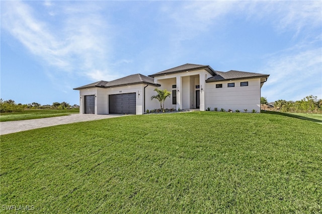 prairie-style home with a garage and a front lawn