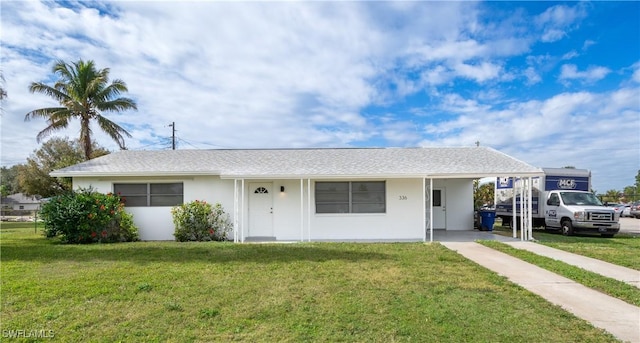 ranch-style house with a front lawn and a carport