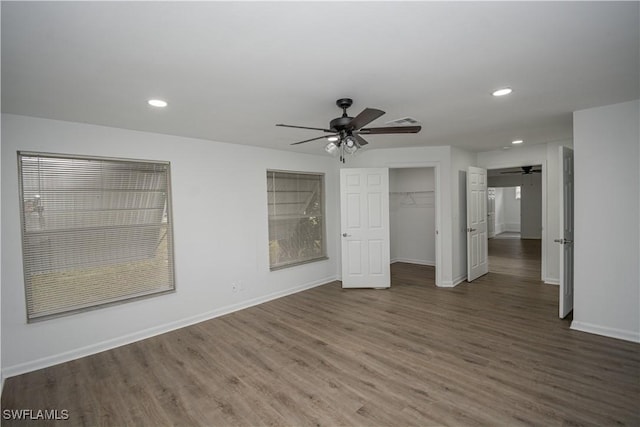 unfurnished bedroom with dark wood-type flooring, a closet, and ceiling fan